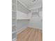 Spacious walk-in closet features built-in shelves and wood closet rods at 1412 Sagamore Dr, Louisburg, NC 27549