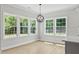 Sun-filled dining area features large windows and a modern chandelier at 1412 Sagamore Dr, Louisburg, NC 27549
