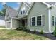 View of the side of the home showcasing its manicured landscaping and craftsman details at 1412 Sagamore Dr, Louisburg, NC 27549