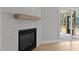 Close-up of the fireplace with white hexagon tiles and wooden mantle at 1412 Sagamore Dr, Louisburg, NC 27549