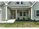 View of the home's entryway with charming landscaping and craftsman style details at 1412 Sagamore Dr, Louisburg, NC 27549