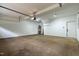 Spacious garage featuring concrete flooring, a utility water heater, and an automatic door at 1412 Sagamore Dr, Louisburg, NC 27549