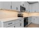 The stylish kitchen features white cabinetry and stainless steel appliances at 1412 Sagamore Dr, Louisburg, NC 27549