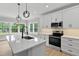 Bright kitchen with stainless steel appliances, island, and sleek pendant lighting at 1412 Sagamore Dr, Louisburg, NC 27549