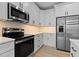 Stainless steel appliances and white cabinets enhance the contemporary kitchen at 1412 Sagamore Dr, Louisburg, NC 27549