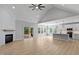 Open-concept living space boasts vaulted ceilings, a fireplace, and access to a screened porch at 1412 Sagamore Dr, Louisburg, NC 27549