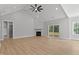 Bright living room features a modern fireplace, vaulted ceiling, and sliding doors at 1412 Sagamore Dr, Louisburg, NC 27549