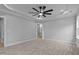 Neutral bedroom boasts plush carpet, tray ceiling, and en-suite bathroom access at 1412 Sagamore Dr, Louisburg, NC 27549