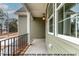 Inviting covered porch with black railing and pendant light fixture at 1412 Sagamore Dr, Louisburg, NC 27549