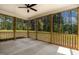 An outdoor screened-in porch providing views of a lush, wooded area with natural light at 1412 Sagamore Dr, Louisburg, NC 27549
