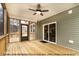 A screened porch with wood floors, ceiling fan, and views of the outdoors at 1412 Sagamore Dr, Louisburg, NC 27549