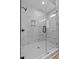 Modern walk-in shower with decorative tile, black hardware, and glass enclosure at 1412 Sagamore Dr, Louisburg, NC 27549