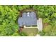 Aerial view of a charming home nestled among mature trees, showcasing the private backyard at 146 Bennett Pl, Clayton, NC 27527