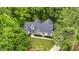 Aerial view of a home with a well-maintained lawn, surrounded by mature trees in a serene setting at 146 Bennett Pl, Clayton, NC 27527