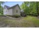Exterior of the home featuring a spacious yard, deck, and access to nature at 146 Bennett Pl, Clayton, NC 27527