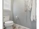 Bathroom with a toilet, towel rack, and window with shades at 146 Bennett Pl, Clayton, NC 27527