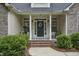 Charming front porch with brick steps, white columns, and lush landscaping at 146 Bennett Pl, Clayton, NC 27527