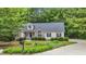 Charming home with manicured lawn and flowering plants surrounding the front yard at 146 Bennett Pl, Clayton, NC 27527