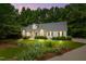 A charming single-Gathering home with lush landscaping and a well-manicured lawn at twilight at 146 Bennett Pl, Clayton, NC 27527