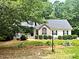 Charming single-Gathering home with beautiful landscaping and mature trees surrounding the property at 146 Bennett Pl, Clayton, NC 27527