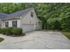 Attached garage with a large concrete driveway and low-maintenance landscaping at 146 Bennett Pl, Clayton, NC 27527