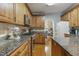 Bright kitchen featuring wood cabinets, granite countertops, stainless steel appliances and hardwood flooring at 146 Bennett Pl, Clayton, NC 27527
