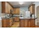 Cozy kitchen with hardwood floors, stainless appliances, and granite countertops provides home cooking space at 146 Bennett Pl, Clayton, NC 27527