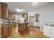 Spacious kitchen with hardwood floors, granite counters, and a view into the living room at 146 Bennett Pl, Clayton, NC 27527