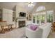 Bright living room features a fireplace, built-in shelving, and french doors to the outdoor deck at 146 Bennett Pl, Clayton, NC 27527