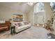 The living room offers an inviting view of the entryway, kitchen and backyard through french doors at 146 Bennett Pl, Clayton, NC 27527