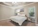 This spacious bedroom has two windows and neutral walls and carpet at 146 Bennett Pl, Clayton, NC 27527
