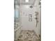 White tiled shower with glass door and accent tile floor and window at 146 Bennett Pl, Clayton, NC 27527