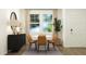 Bright dining area features a table for six, stylish lighting, and large windows at 1538 Crescent Townes Way, Raleigh, NC 27604