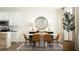 Stylishly designed dining area shows seating for six adjacent to the modern kitchen at 1538 Crescent Townes Way, Raleigh, NC 27604