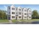 Beautiful new construction townhome with three stories, black window frames, and bright white siding at 1538 Crescent Townes Way, Raleigh, NC 27604