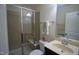 Clean bathroom featuring a glass-enclosed shower, vanity with sink, and neutral tiling at 1549 Lily Creek Dr, Cary, NC 27518