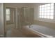 Bright bathroom featuring a soaking tub and a glass-enclosed shower at 1549 Lily Creek Dr, Cary, NC 27518