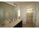 Bright bathroom featuring double sinks, large mirror and access to the toilet and tub/shower at 1549 Lily Creek Dr, Cary, NC 27518