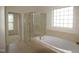 Spacious bathroom with a garden tub and separate glass enclosed shower at 1549 Lily Creek Dr, Cary, NC 27518