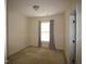 Simple bedroom featuring a window, neutral carpeting, and freshly painted walls at 1549 Lily Creek Dr, Cary, NC 27518