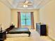 This primary bedroom has a vaulted ceiling, a ceiling fan, and a large window at 1549 Lily Creek Dr, Cary, NC 27518