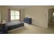 Spacious bedroom with a large window, plush carpeting, and a stylish blue dresser at 1549 Lily Creek Dr, Cary, NC 27518