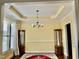 Cozy dining room features a decorative ceiling, hardwood floors, and wainscoting at 1549 Lily Creek Dr, Cary, NC 27518