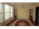 Dining room with wood floors, elegant chandelier, and decorative rug and display cases at 1549 Lily Creek Dr, Cary, NC 27518