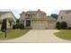 Two-story home featuring a two-car garage, stone accents and well-manicured landscaping at 1549 Lily Creek Dr, Cary, NC 27518