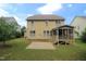 Back exterior of the home with a patio and screened-in porch overlooking a grassy lawn at 1549 Lily Creek Dr, Cary, NC 27518