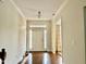 Bright foyer with hardwood floors, white trim, and a transom window above the front door at 1549 Lily Creek Dr, Cary, NC 27518