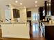 Open kitchen with granite countertops, dark wood cabinets, and stainless steel appliances at 1549 Lily Creek Dr, Cary, NC 27518