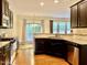 Kitchen features stainless steel appliances, dark wood cabinets, and view to patio at 1549 Lily Creek Dr, Cary, NC 27518