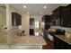 Kitchen showcasing granite countertops, stainless steel appliances, and dark cabinets with hardwood floors at 1549 Lily Creek Dr, Cary, NC 27518